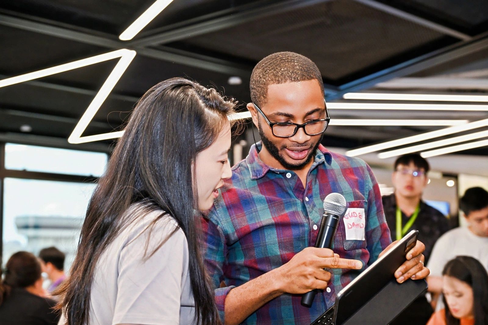 Young people working on laptops in a modern office